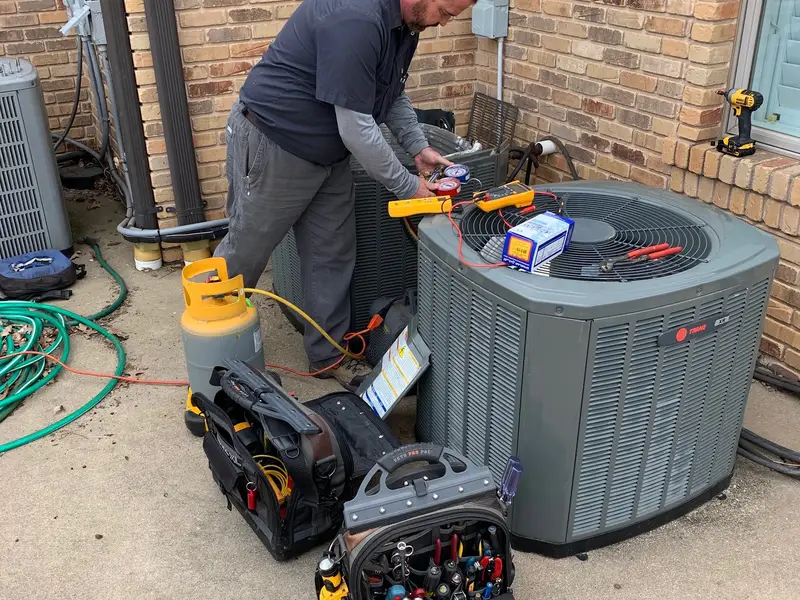TLC technician servicing an AC unit